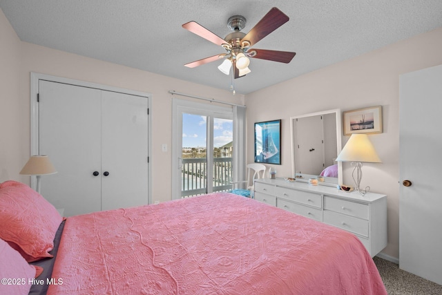 bedroom featuring access to exterior, carpet, a textured ceiling, and ceiling fan