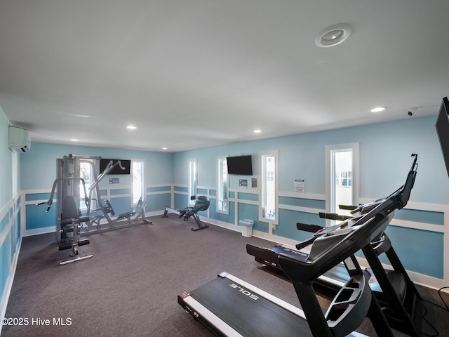 exercise room with a wall mounted air conditioner