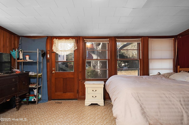 bedroom featuring wood walls