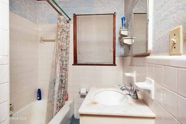 bathroom with vanity, tile walls, and shower / bath combination with curtain