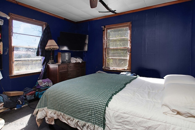 bedroom with multiple windows, ornamental molding, carpet floors, and ceiling fan