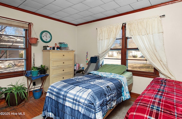 bedroom with hardwood / wood-style flooring and crown molding