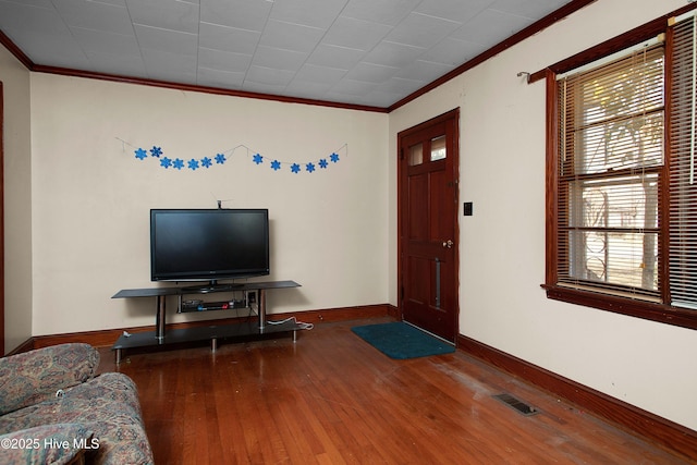 living room featuring crown molding and wood-type flooring