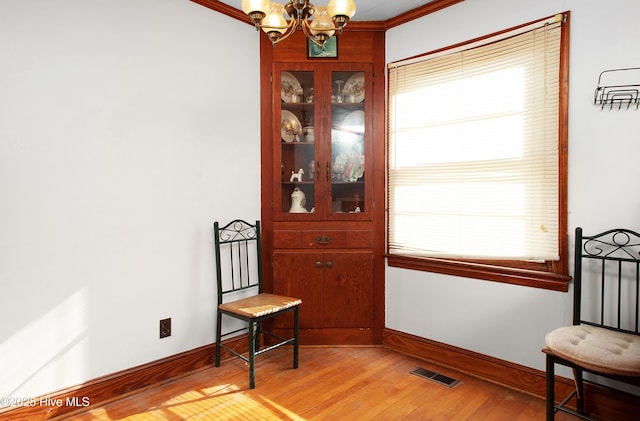 sitting room with a notable chandelier and light wood-type flooring