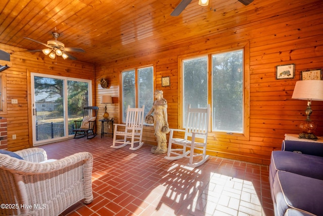 sunroom featuring ceiling fan and wooden ceiling