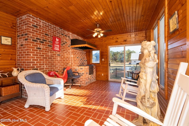 sunroom featuring ceiling fan and wood ceiling