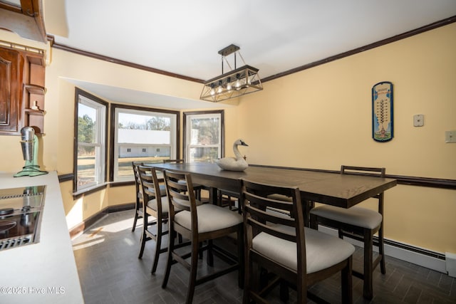 dining space with dark parquet floors and ornamental molding