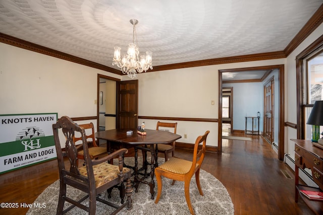 dining room featuring a wealth of natural light, ornamental molding, dark hardwood / wood-style floors, and an inviting chandelier