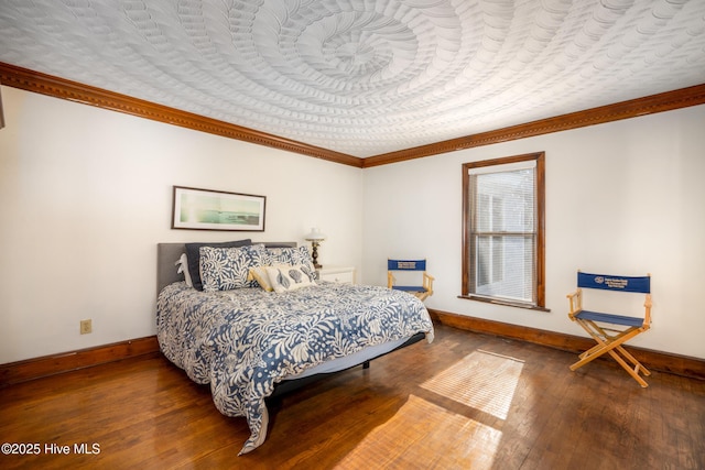 bedroom featuring wood-type flooring and crown molding