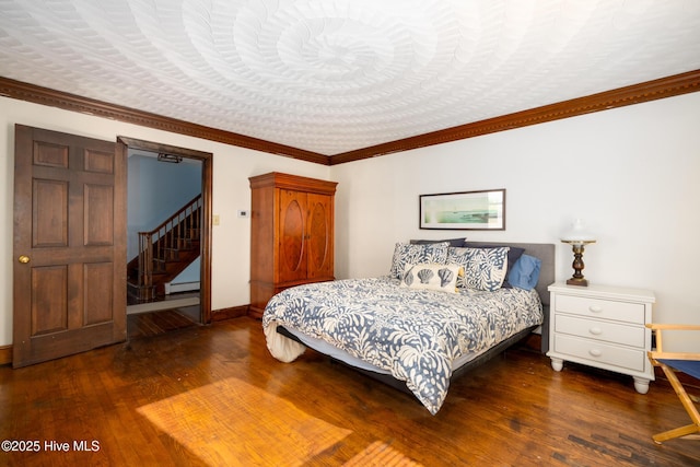 bedroom with crown molding, dark wood-type flooring, and a baseboard radiator