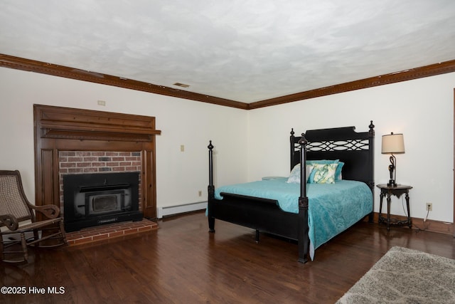 bedroom with ornamental molding, dark hardwood / wood-style flooring, and a baseboard heating unit