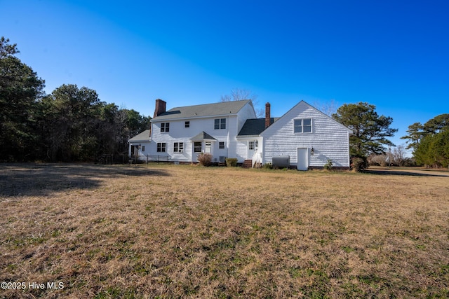 back of house with a lawn