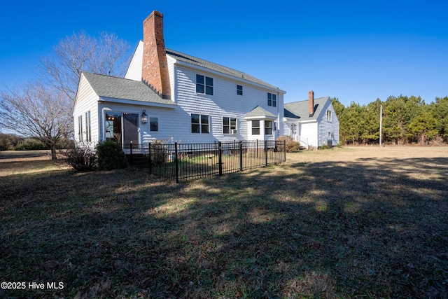 back of property featuring a lawn