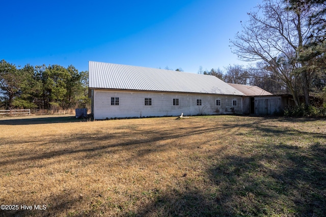 rear view of property with a lawn