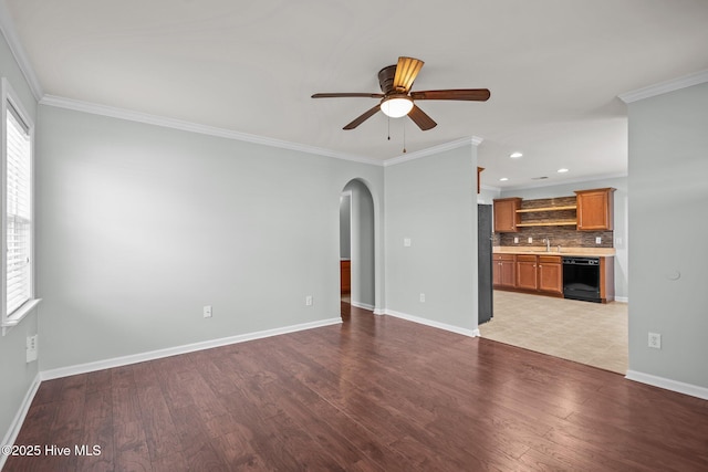 unfurnished living room featuring ornamental molding, ceiling fan, light wood-type flooring, and sink