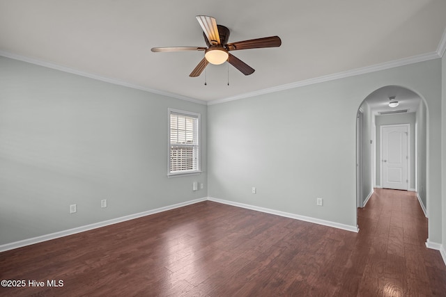 empty room with ceiling fan, dark wood-type flooring, and ornamental molding