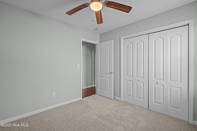 unfurnished bedroom with ceiling fan, a closet, and carpet