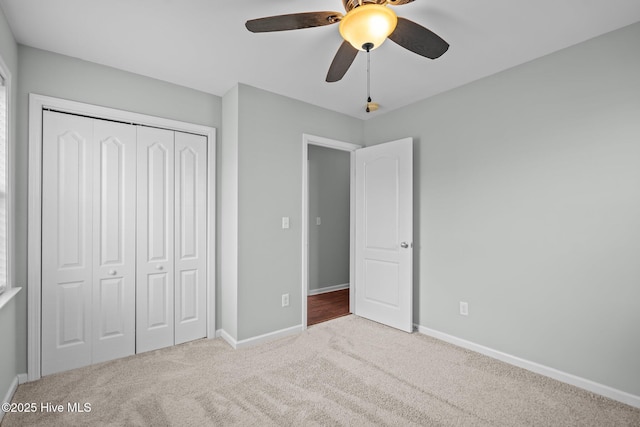 unfurnished bedroom featuring a closet, ceiling fan, and carpet floors