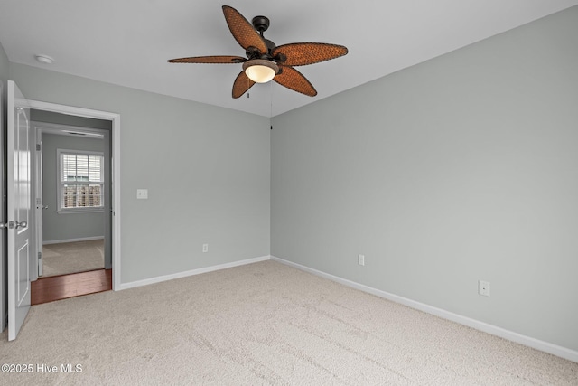 empty room featuring light colored carpet and ceiling fan