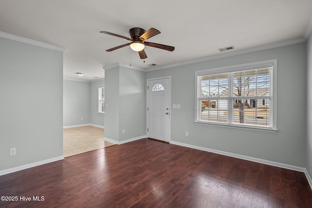 entryway with wood-type flooring, ceiling fan, a wealth of natural light, and crown molding