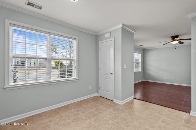 tiled empty room featuring ceiling fan and crown molding