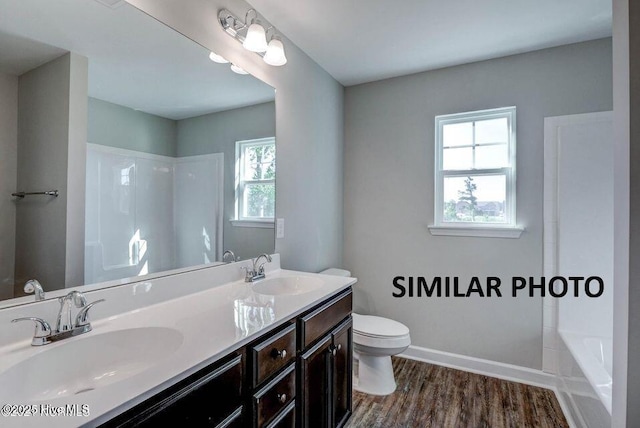 bathroom featuring vanity, hardwood / wood-style floors, and toilet