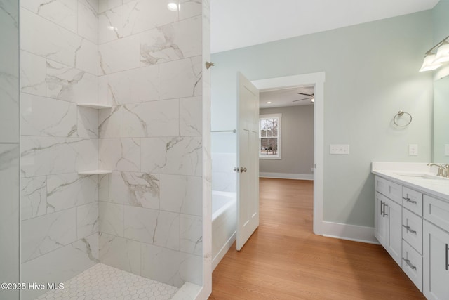 bathroom with vanity, hardwood / wood-style floors, and shower with separate bathtub