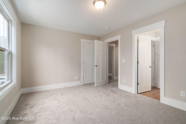 unfurnished bedroom with light carpet