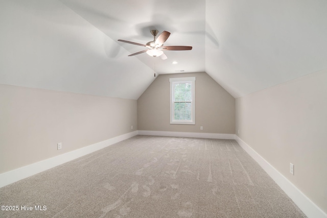 bonus room with lofted ceiling, ceiling fan, and carpet