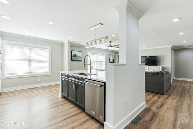 kitchen with sink, hanging light fixtures, stainless steel dishwasher, hardwood / wood-style flooring, and ornamental molding