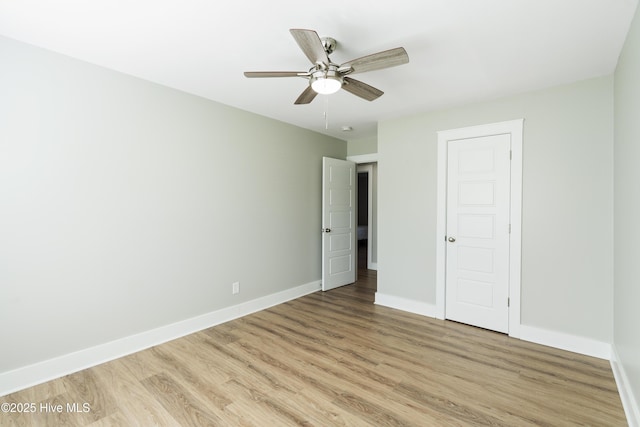 unfurnished bedroom with ceiling fan, a closet, and light hardwood / wood-style floors