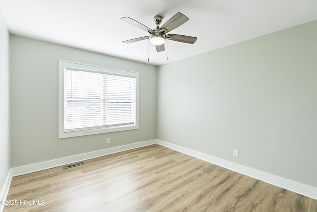 unfurnished room featuring light wood-type flooring and ceiling fan