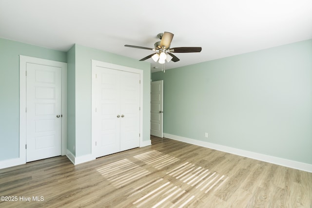 unfurnished bedroom featuring light wood-type flooring, a closet, and ceiling fan