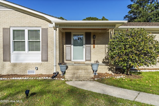 entrance to property with a lawn