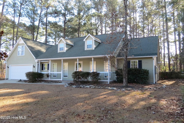 cape cod home featuring a porch and a garage