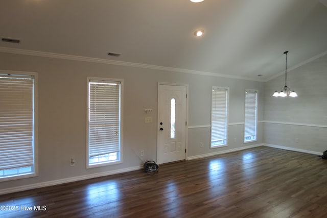 foyer entrance featuring vaulted ceiling, crown molding, dark hardwood / wood-style floors, and a notable chandelier