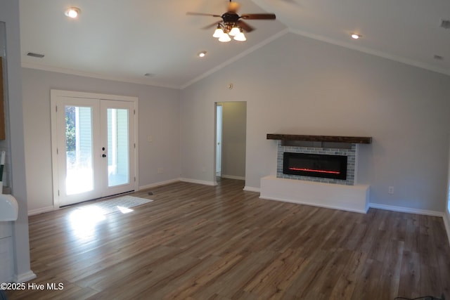 unfurnished living room featuring ceiling fan, dark hardwood / wood-style flooring, a fireplace, and french doors