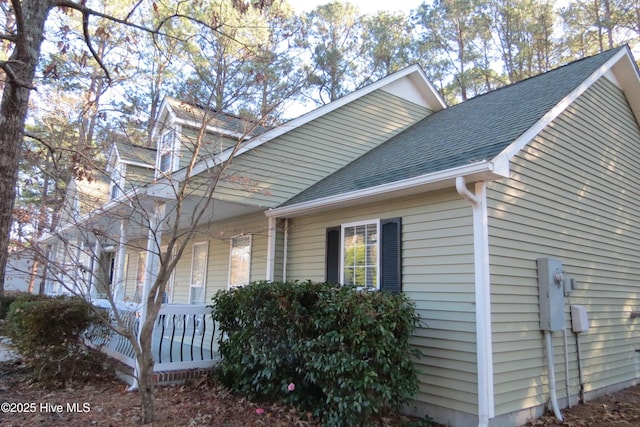 view of side of property featuring covered porch