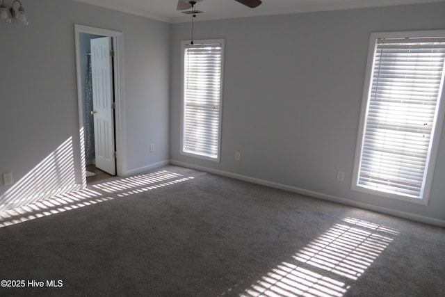 empty room with ceiling fan, carpet, and a healthy amount of sunlight