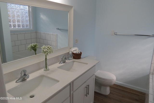 bathroom with vanity, hardwood / wood-style flooring, and toilet