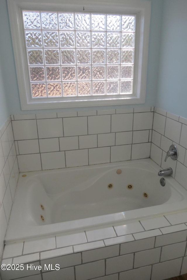 bathroom featuring tiled bath