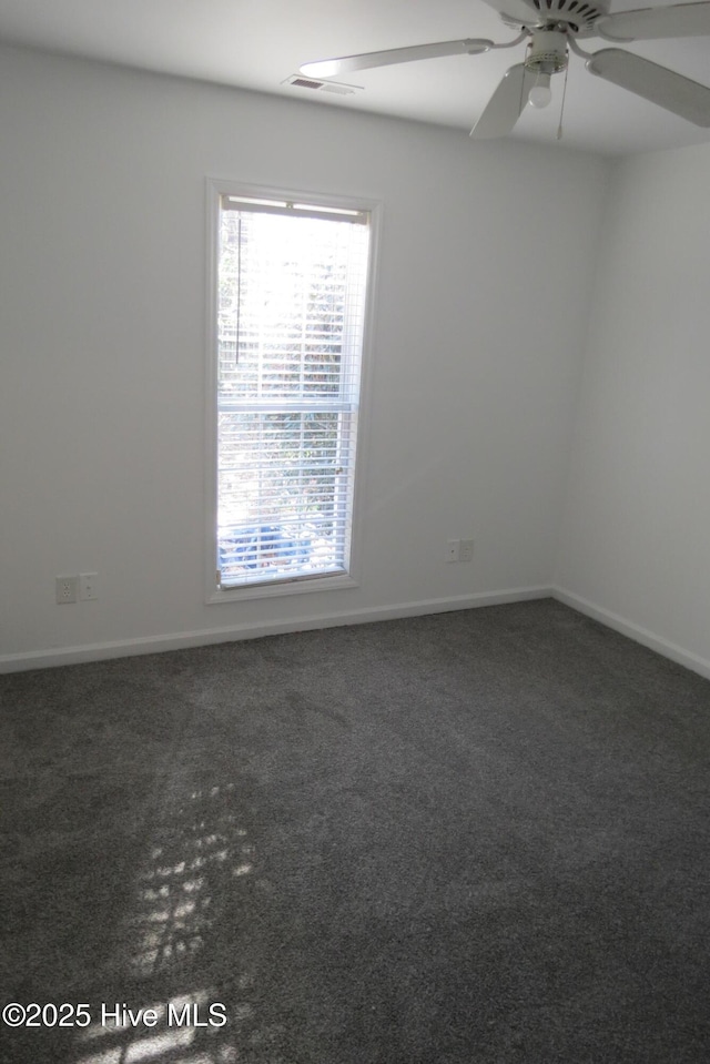 carpeted spare room with ceiling fan