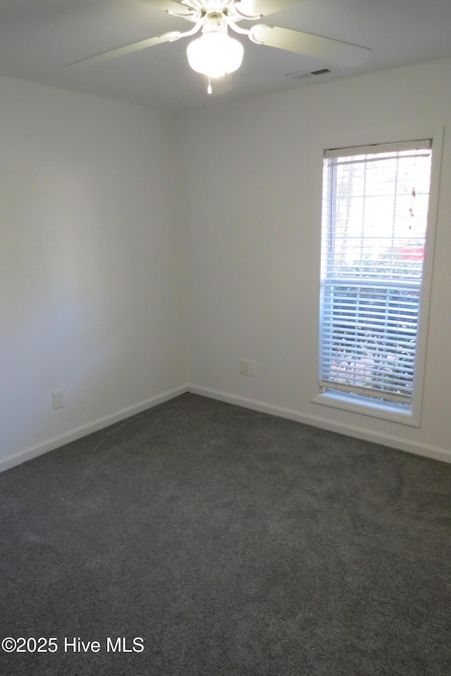 carpeted spare room with ceiling fan