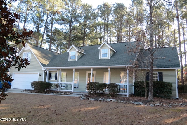 cape cod house with covered porch and a garage