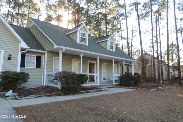 new england style home featuring covered porch