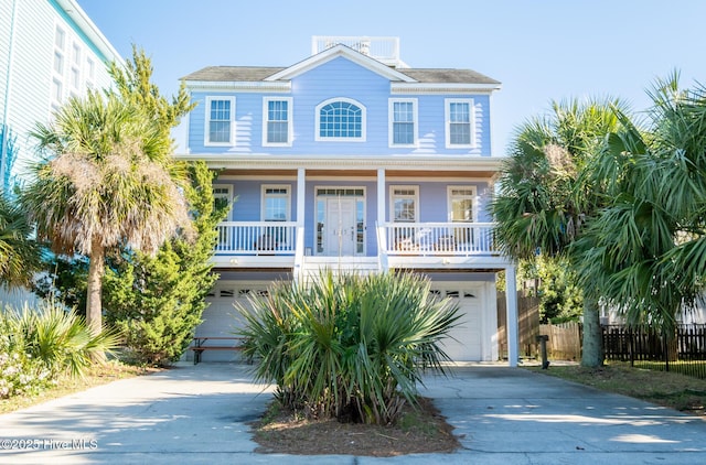 raised beach house featuring a garage