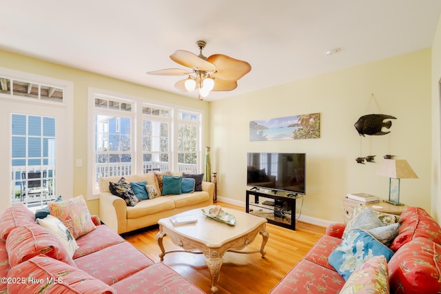 living room with light wood-type flooring and ceiling fan