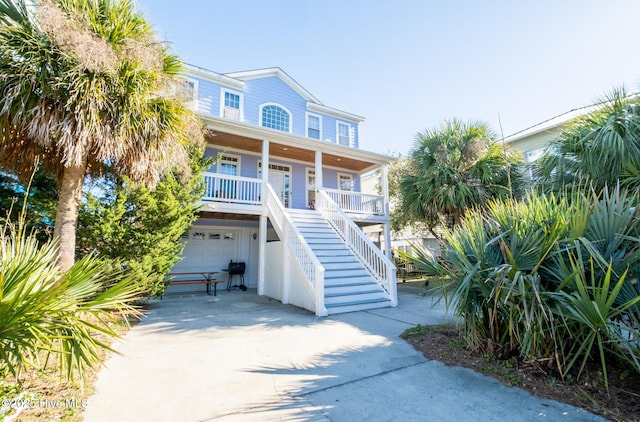 beach home featuring a porch and a garage