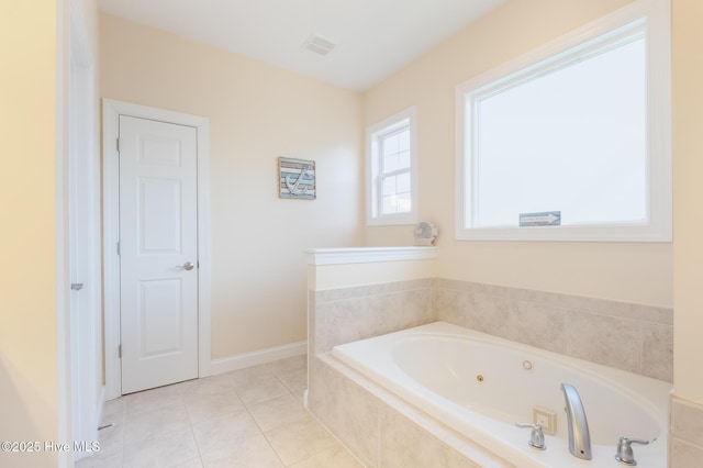 bathroom featuring a relaxing tiled tub and tile patterned floors