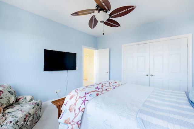 carpeted bedroom featuring ceiling fan and a closet